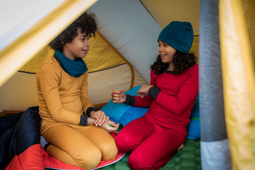 Kids wear their merino wool thermals while camping in the out doors
